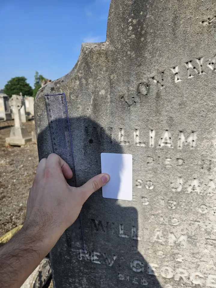 A hard body shadow covering the card and gravestone lettering