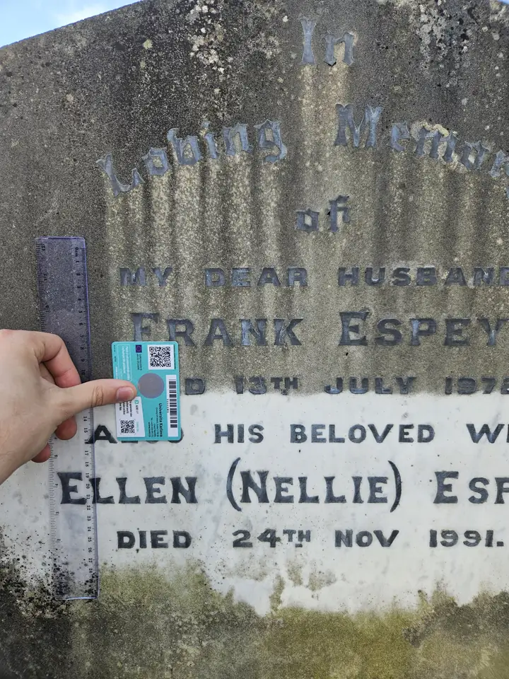 A well-lit gravestone photo where the card and lettering stay readable